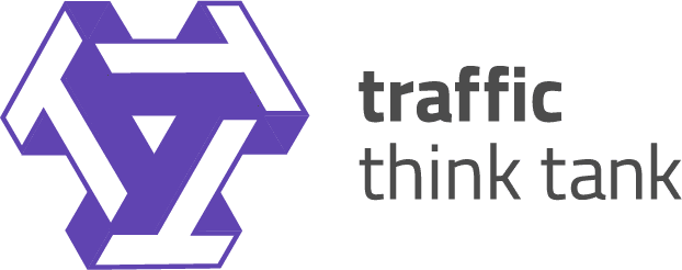 Traffic think tank logo. Traffic think tank is written in dark grey. To the right are three purple T's arranged into a triangle.